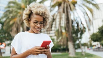 woman looking at mobile device while outside