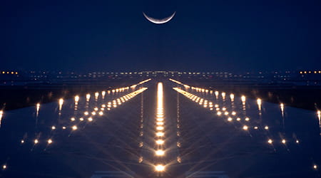 Landing Zone lit up at night with crescent moon