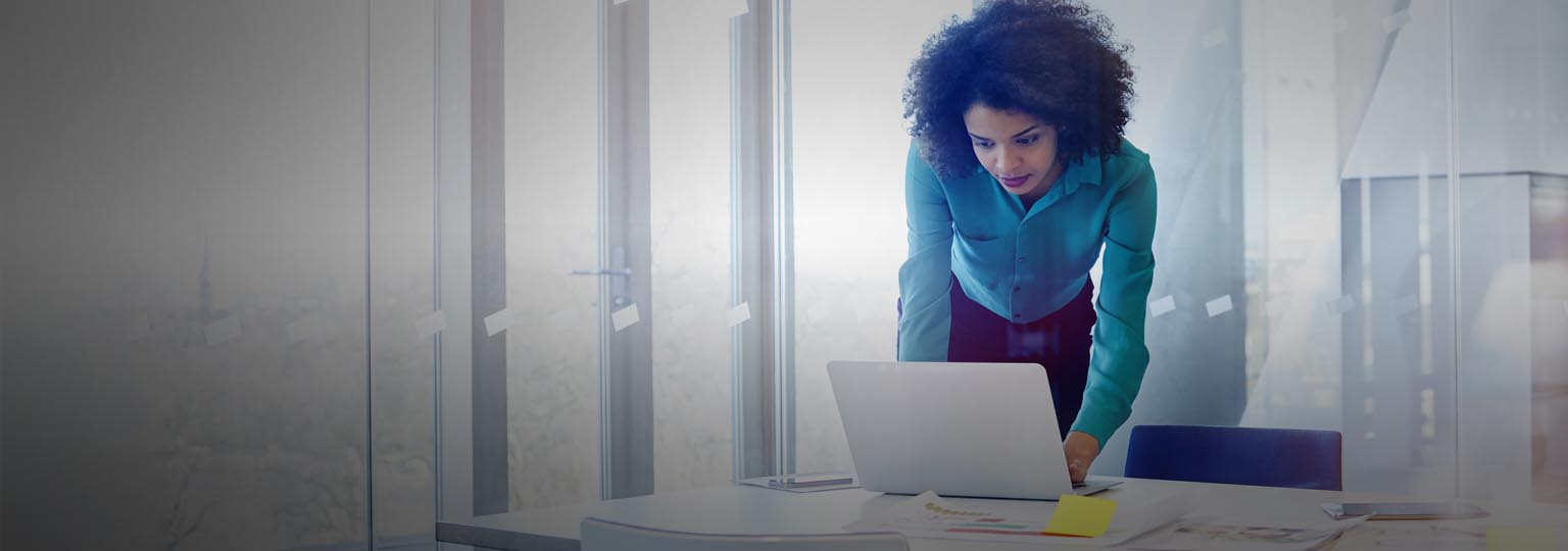 women working on her laptop in conference room