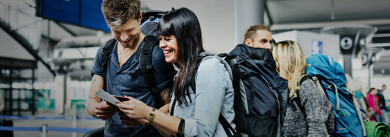 backpackers with smart phone waiting at airline