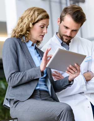 doctor looking at tablet with professional