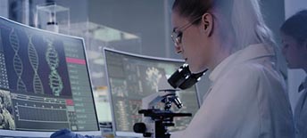 scientist looking at DNA on a screen