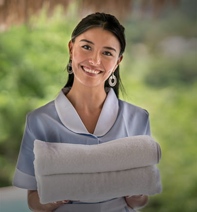 Hotel staff handing towels to guest