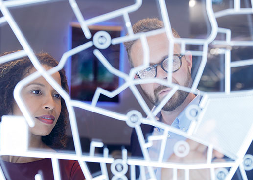Man and woman at work on translucent map