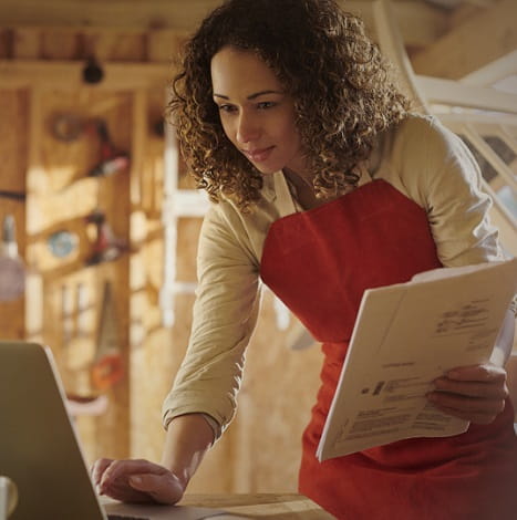 woman at computer with apron on