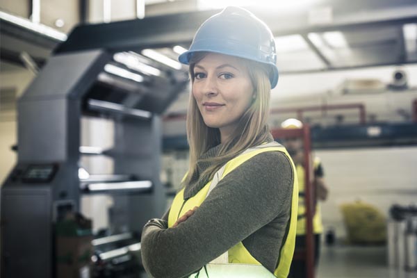 female worker with helmet in manufacturing site