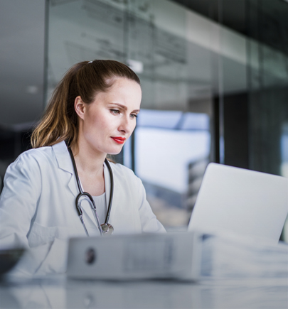 Female doctor using laptop in clinic