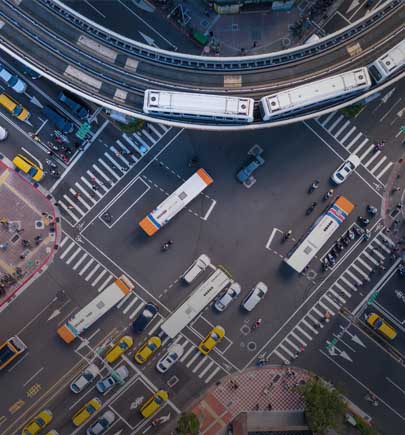 overhead image of buses and cars on roads