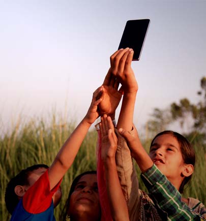 children holding up mobile phone