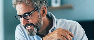man with glasses smiling