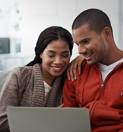 Couple at home looking at a laptop